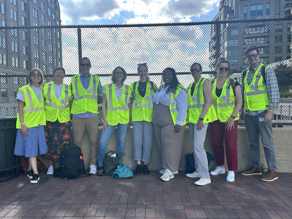 Infrastructure for Public Good team members standing outdoors in reflective safety vests