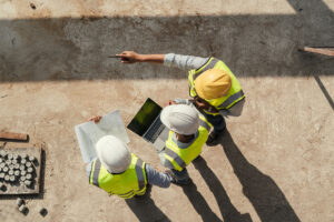 Construction team at site with computer